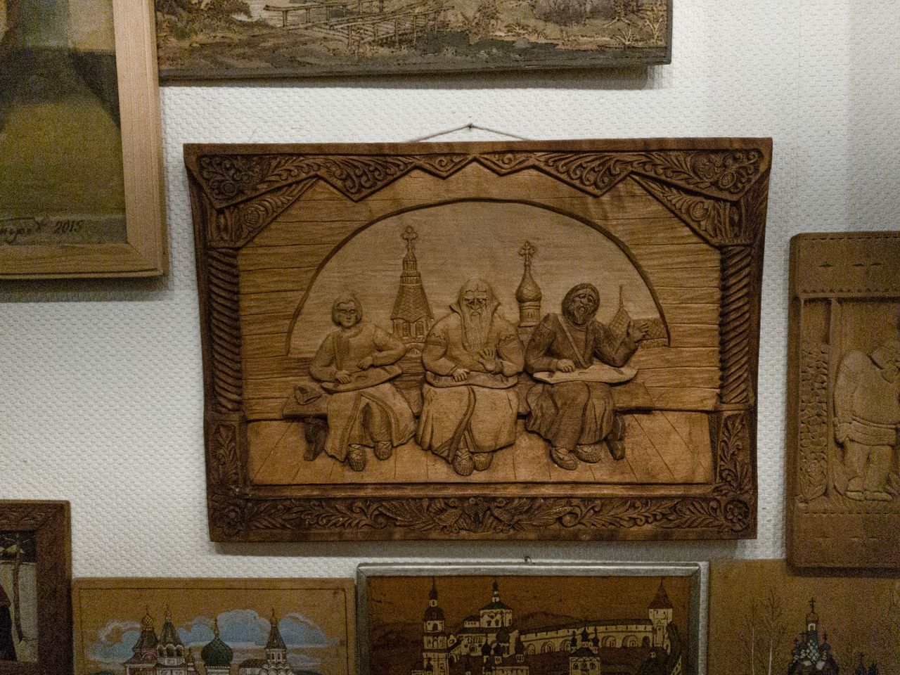 hero-img-02 Detailed bas relief artwork on display in a museum, showcasing wood craftsmanship.